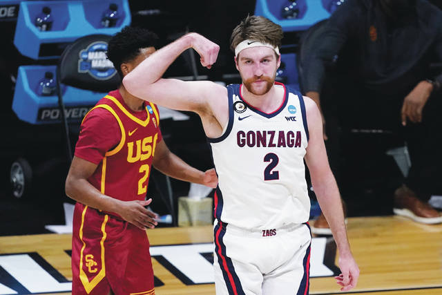 Gonzaga forward Drew Timme flexes in front of USC guard Tahj Eaddy after hitting a shot in Tuesday’s Elite Eight win.
                                 Darron Cummings | AP photo