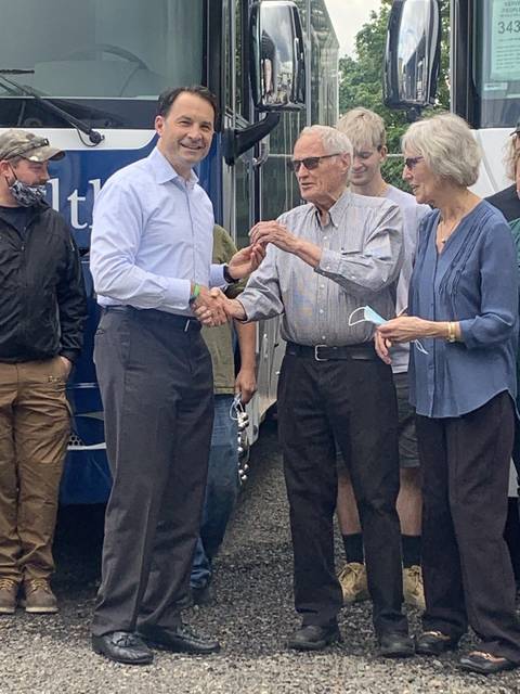 Benco Dental Managing Director Chuck Cohen, center left, receives the keys to ADI Mobile Health from its founder, Tim Kitch, surrounded by members of the ADI team.
                                 Submitted photo
