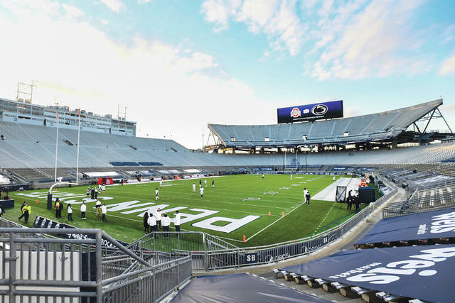 Penn State players warm up in Beaver Stadium during an NCAA game against Ohio State in State College on Saturday, Oct. 31, 2020.
                                 AP file photo