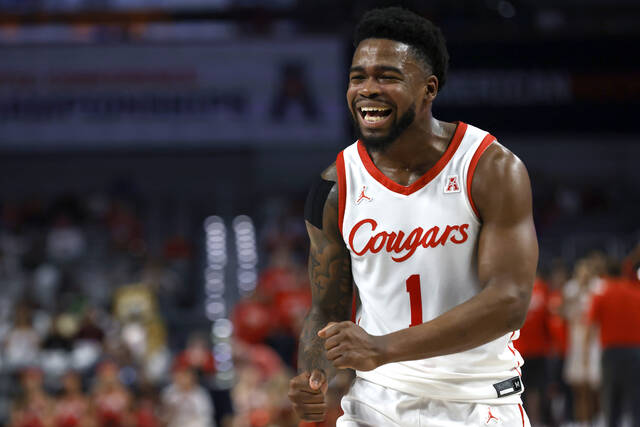 Houston guard Jamal Shead reacts after a basket against Cincinnati during the first half of an NCAA basketball game in the semifinals of the American Athletic Conference Tournament on Saturday in Fort Worth, Texas.
                                 AP photo