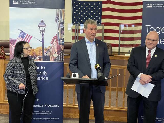 Exeter Borough Mayor Denise Adams, left, and USDA State Director for Rural Development Bob Morgan, right, listen Wednesday morning as U.S. Rep. Matt Cartwright announces that the borough will receive an $8.7 million USDA loan for major infrastructure improvements.
                                 Bill O’Boyle | Times Leader