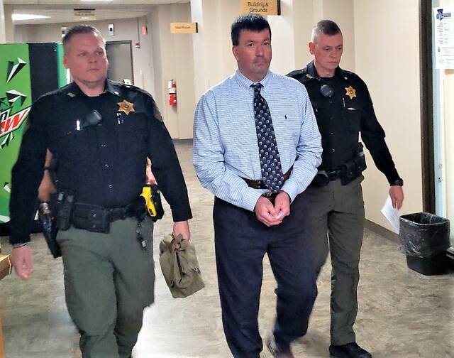 Todd William Bebo is escorted from the Luzerne County Courthouse after a jury convicted him of attempting to kill an former girlfriend in Dallas Township following a three-day trial before Judge David W. Lupas in October.
                                 Ed Lewis | Times Leader
