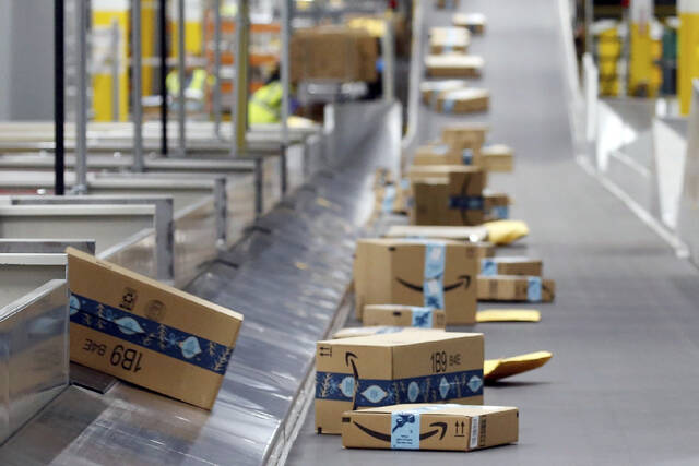 FILE - Amazon packages move along a conveyor at an Amazon warehouse facility on Dec. 17, 2019, in Goodyear, Ariz. July sales events have become a seasonal revenue driver for the retail industry since Amazon launched its first Prime Day back in 2015.
                                 (AP Photo/Ross D. Franklin, File)