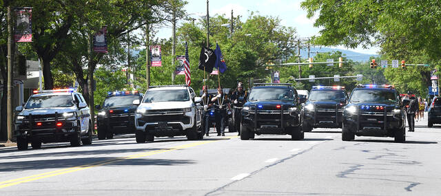 Police Units start the procession down Wyoming Avenue to start the Wed Side Memorial Day Parade Monday.
                                 Mark Moran | For Times Leader