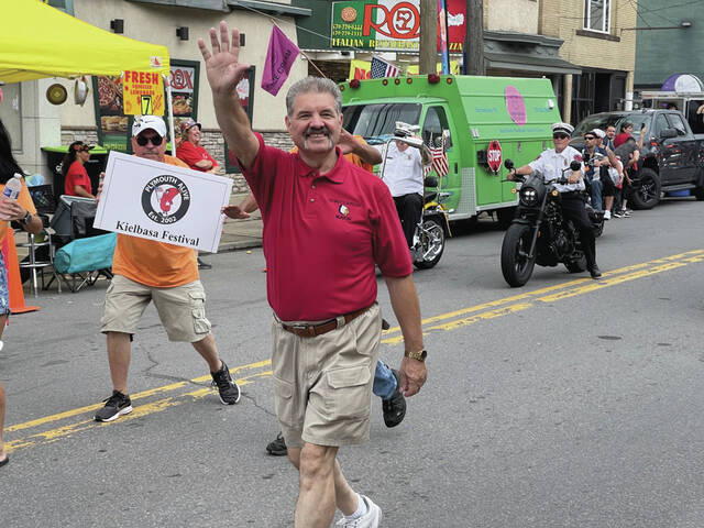 Plymouth Borough Mayor Frank Coughlin waves to spectators as he walks in the 2021 Kielbasa Festival Parade.
                                 Times Leader | File Photo