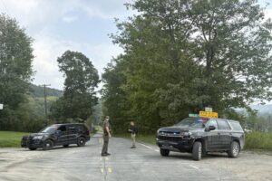 Woman killed by neighbor before responding state troopers were ambushed by gunfire, police say