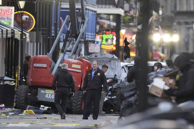 Security personnel investigate the scene on Bourbon Street after a vehicle drove into a crowd on New Orleans’ Canal and Bourbon Street, Wednesday Jan. 1, 2025.
                                 (AP Photo/Gerald Herbert)